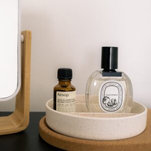 Luxury toiletries sit in a minimalist vanity setup.